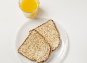 Image showing glass of orange juice and wholemeal toast with lower fat spread