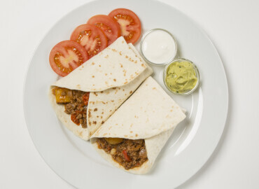 picture showing Mexican tortilla wraps with sour cream and guacamole