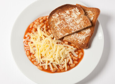 Photo of baked beans on a slice of wholemeal toast with low fat spread and grated cheddar cheese