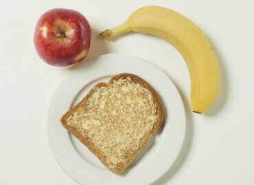 Photo of a banana, apple, and slice of toast with lower fat spread