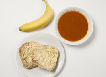Homemade tomato soup and a wholemeal bread roll with lower fat spread, followed by a banana