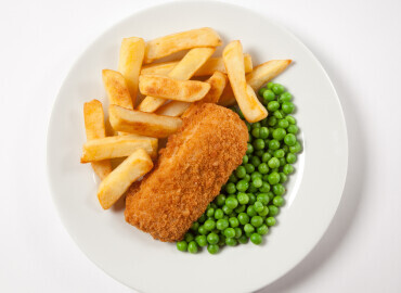 Photo of oven baked haddock with oven chips and vegetables