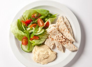 Photo of pitta bread with houmous and a side salad