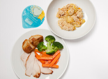 Photo of roast chicken with potatoes and vegetables, homemade apple crumble and a pot of plain yogurt