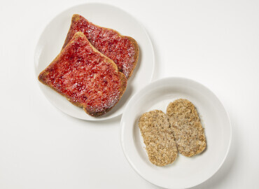 Photo of bowl of wheat bisks and two slices of wholemeal toast with jam