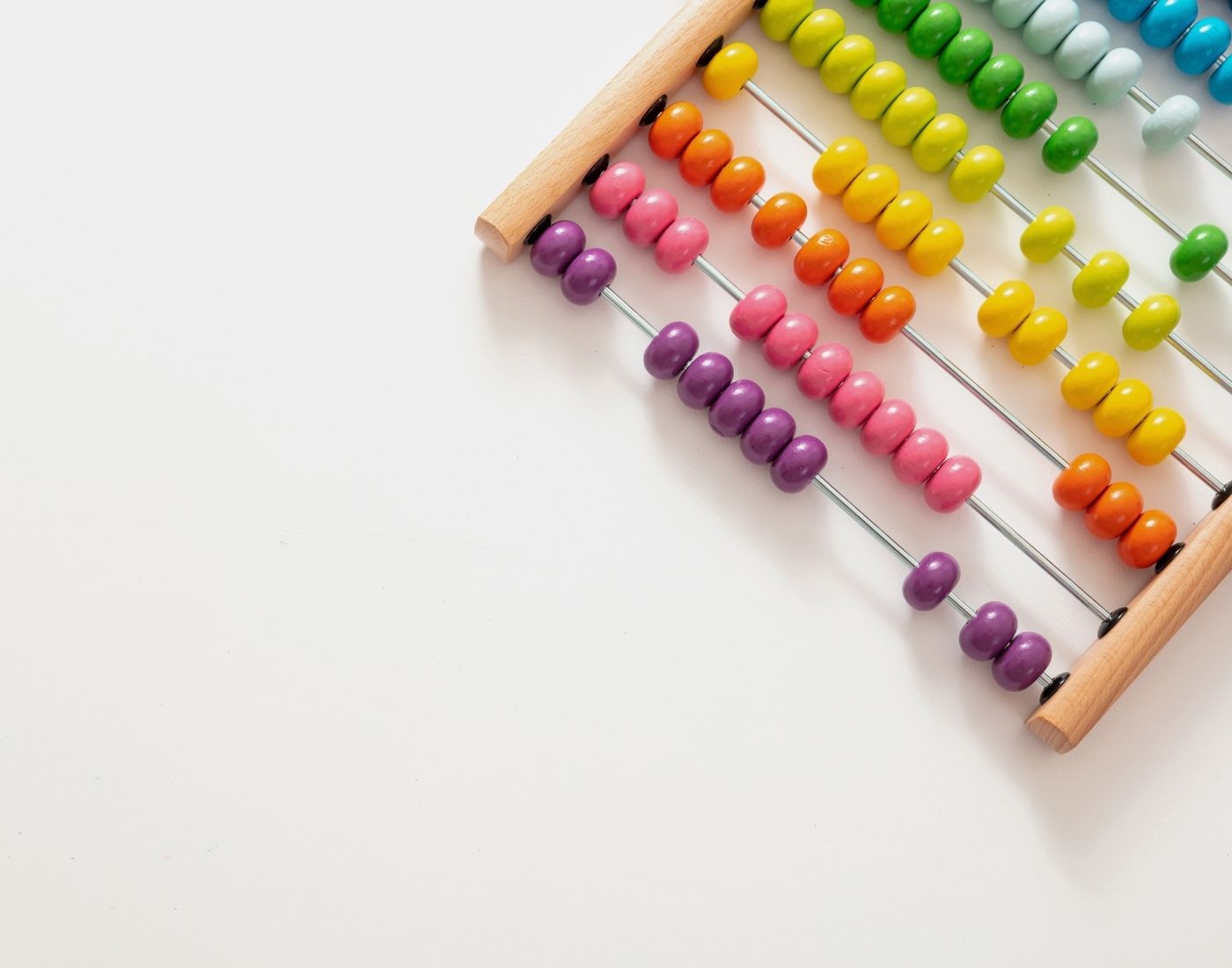 A colorful abacus with rows of beads in purple, yellow, green, and red on a white background.