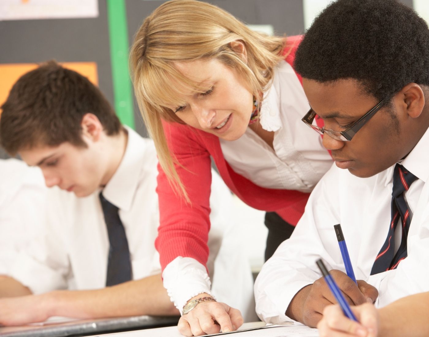 Teacher speaking to secondary school aged boy.