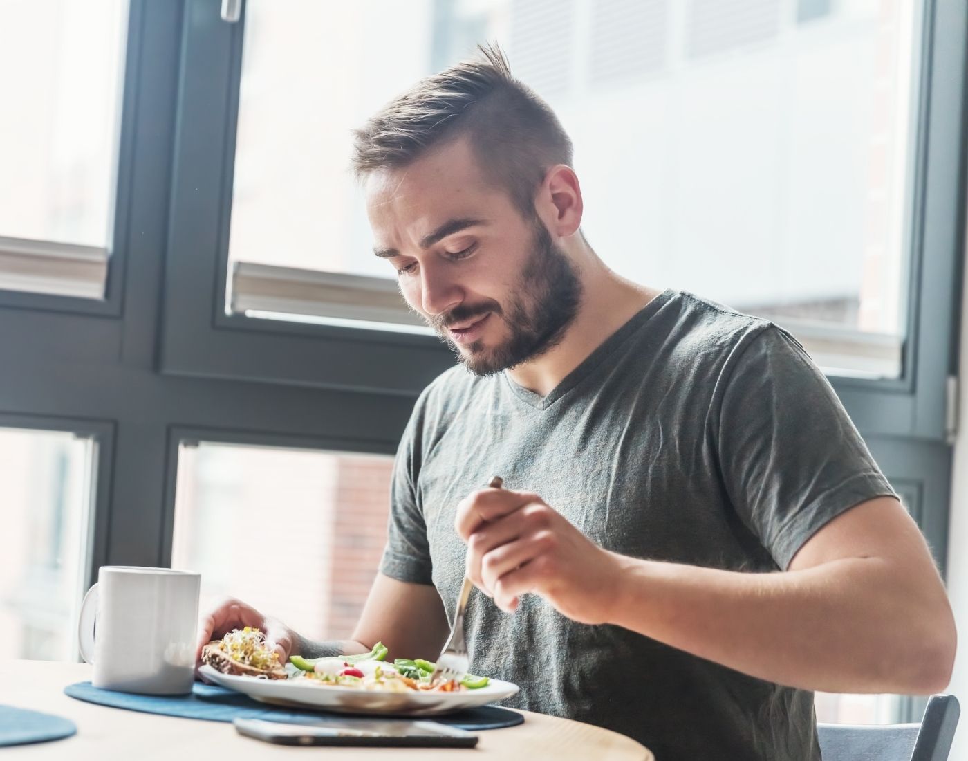 A man eating a healthy meal at home