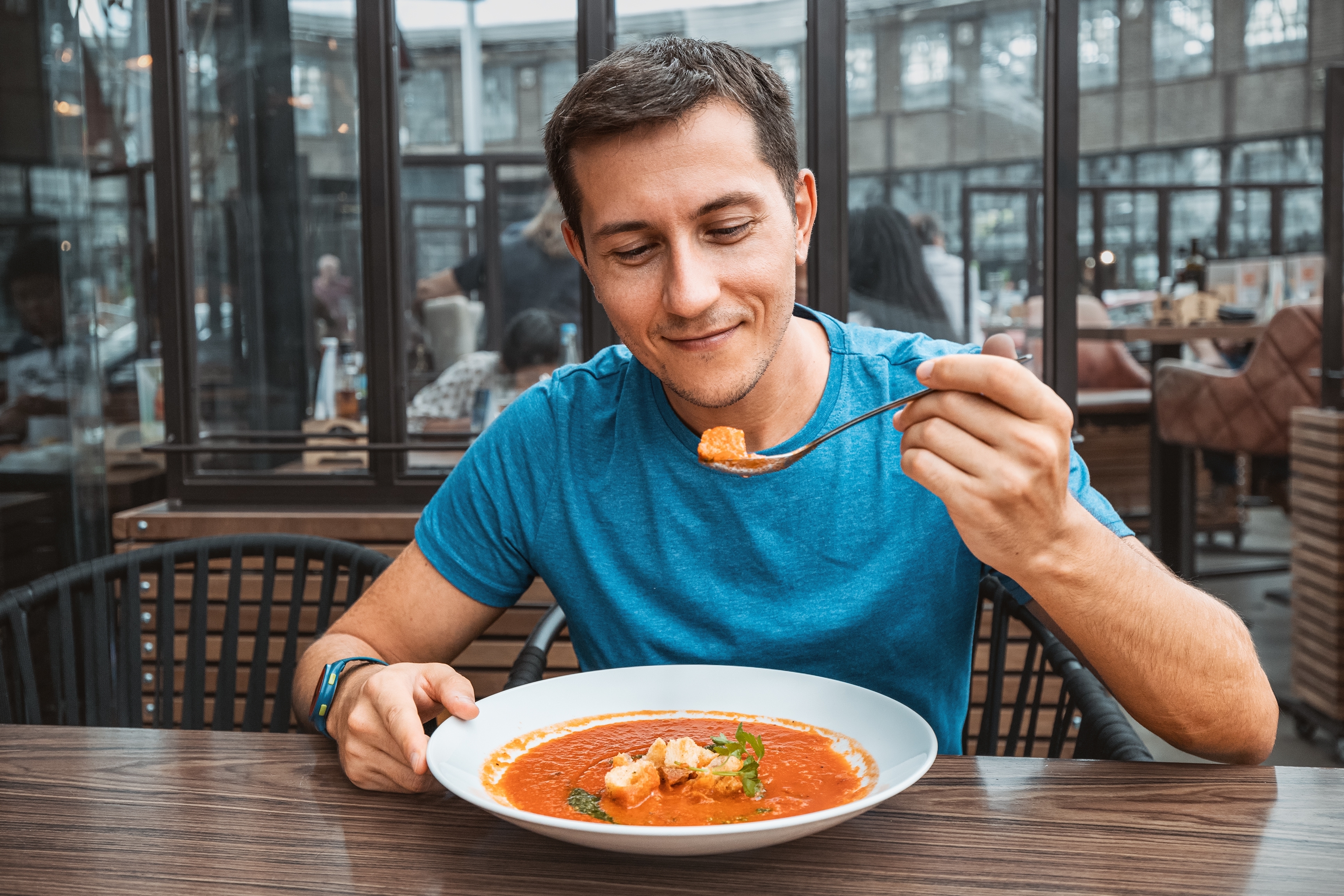 Man eating soup for lunch