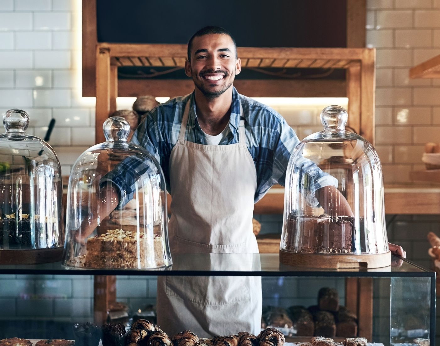 Bakery, happy and portrait of man in cafe ready for serving pastry and baked foods for small business.