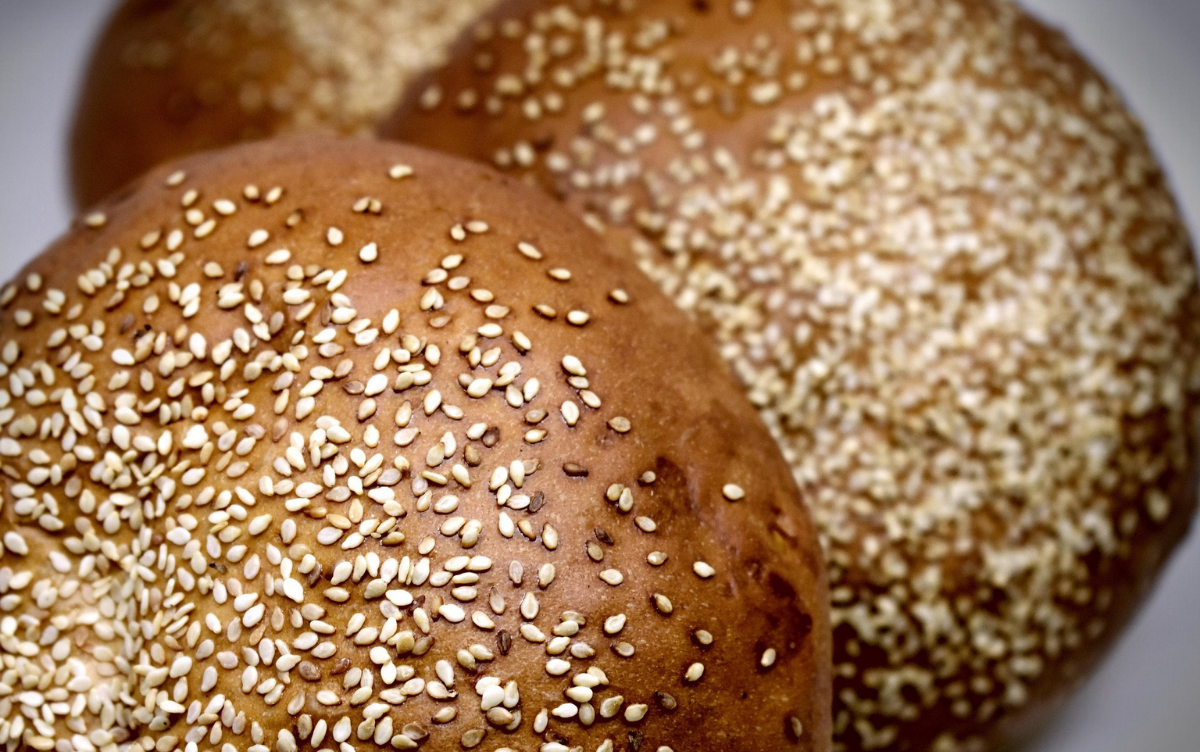A bread roll with sesame seeds on top