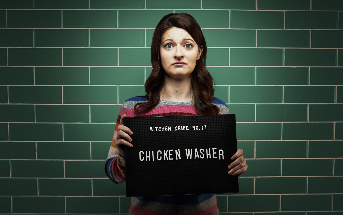 Woman holding mug shot board with words Chicken Washer