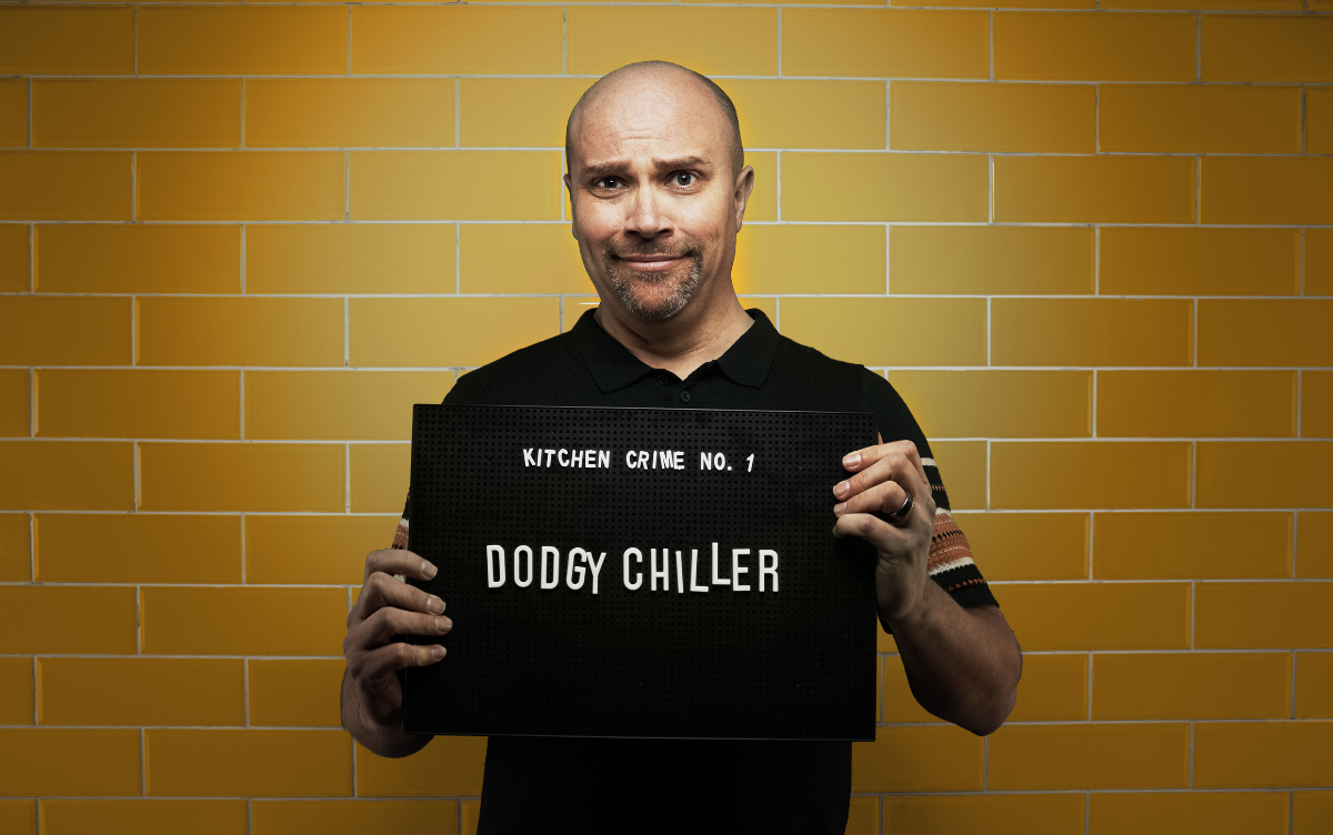 Woman holding mug shot board with words Dodgy Chiller