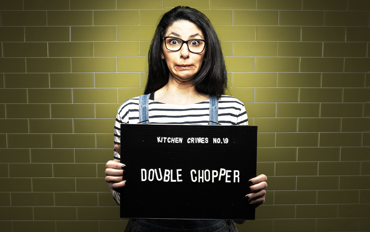 Woman holding mug shot board with words Double Chopper