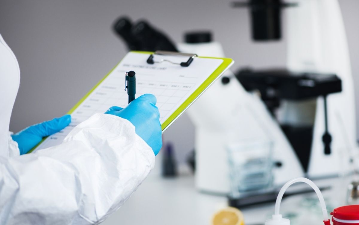 Food safety worker writing on a clipboard.