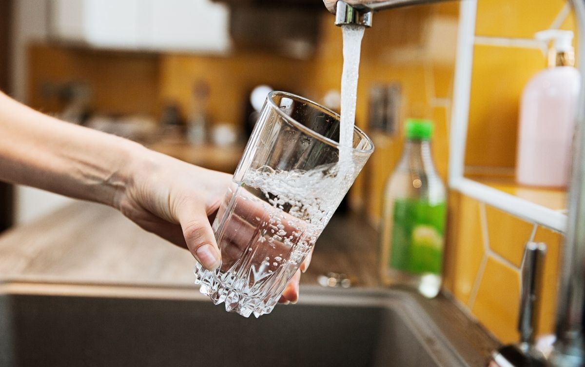 Water pouring into a glass from a tap