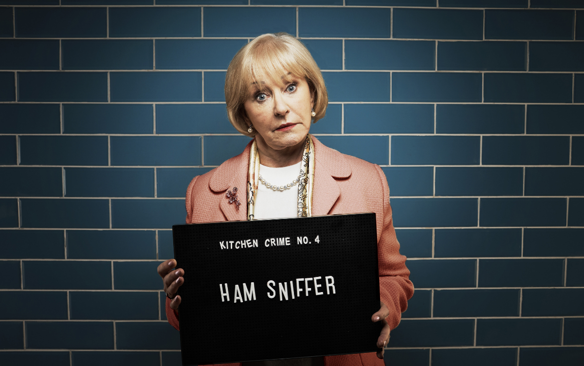 Woman holding mug shot board with words Ham Sniffer
