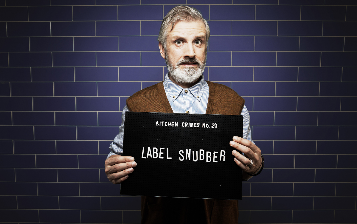Man holding mug shot board with words Label Snubber