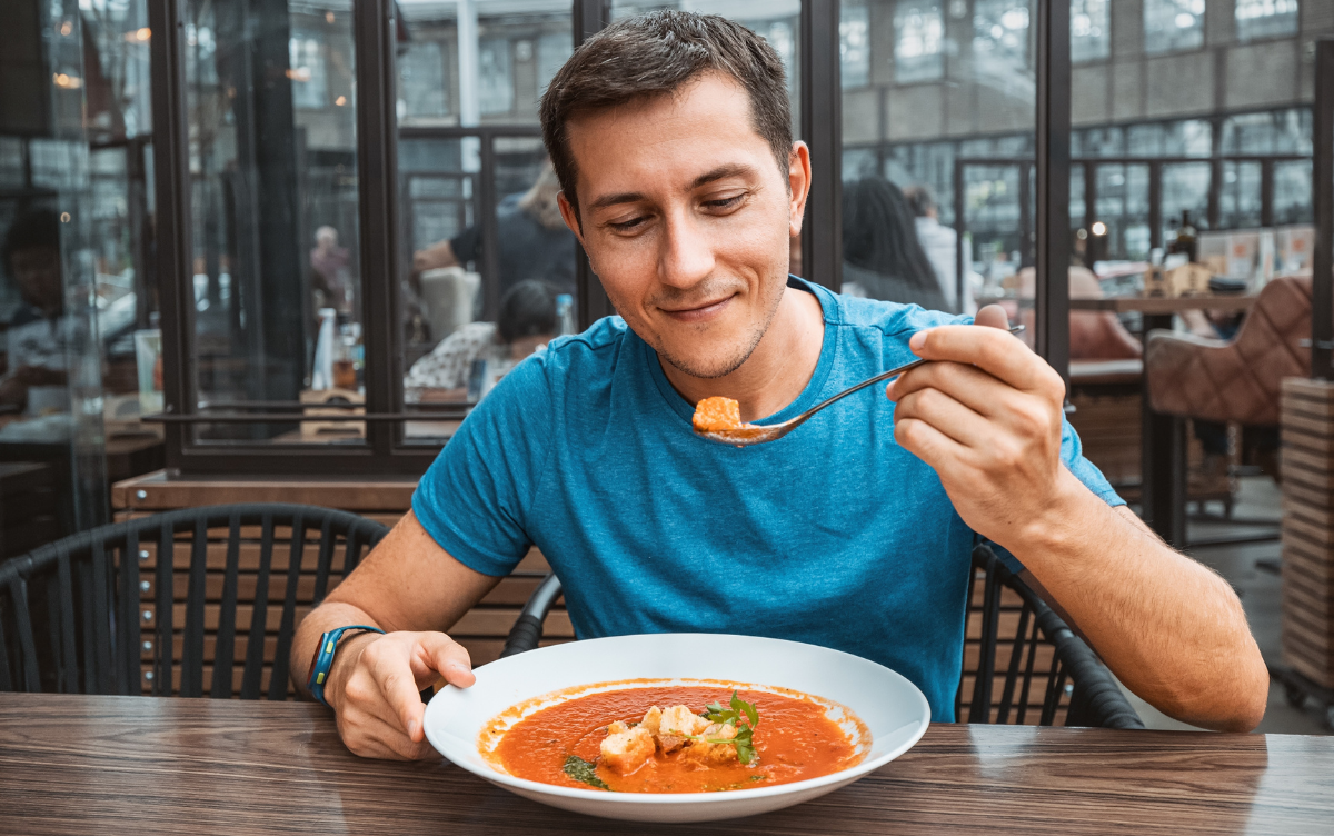 Man eating soup for lunch