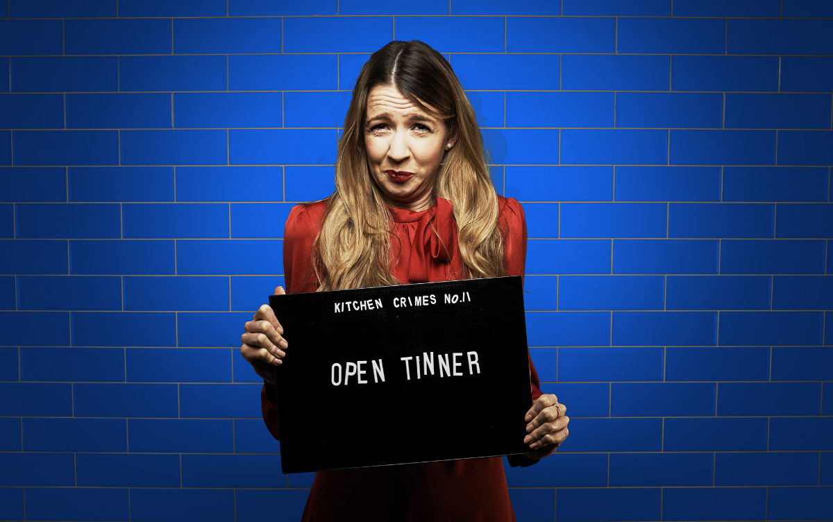 Woman holding mug shot board with words Open Tinner