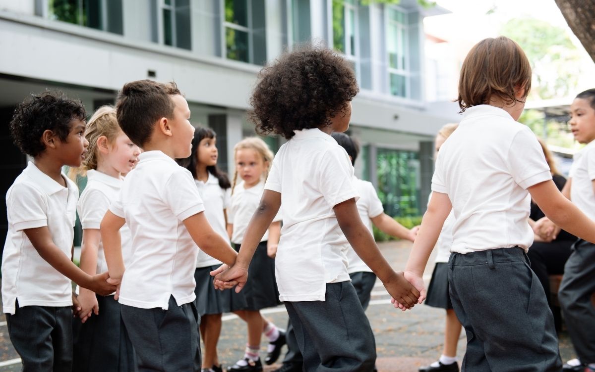 Primary school children holding hands.