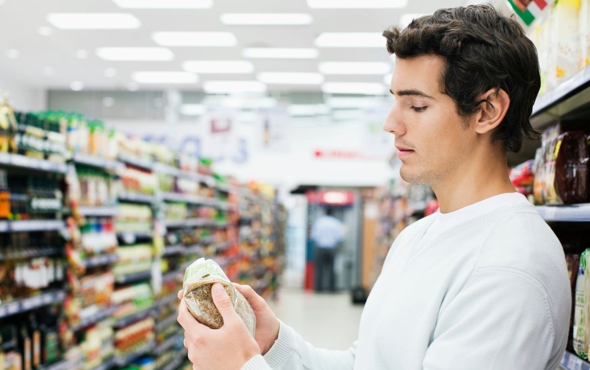 Customer reading packaging in a supermarket
