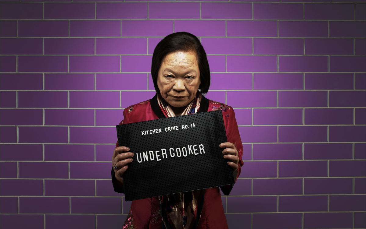 Woman holding mug shot board with words Undercooker