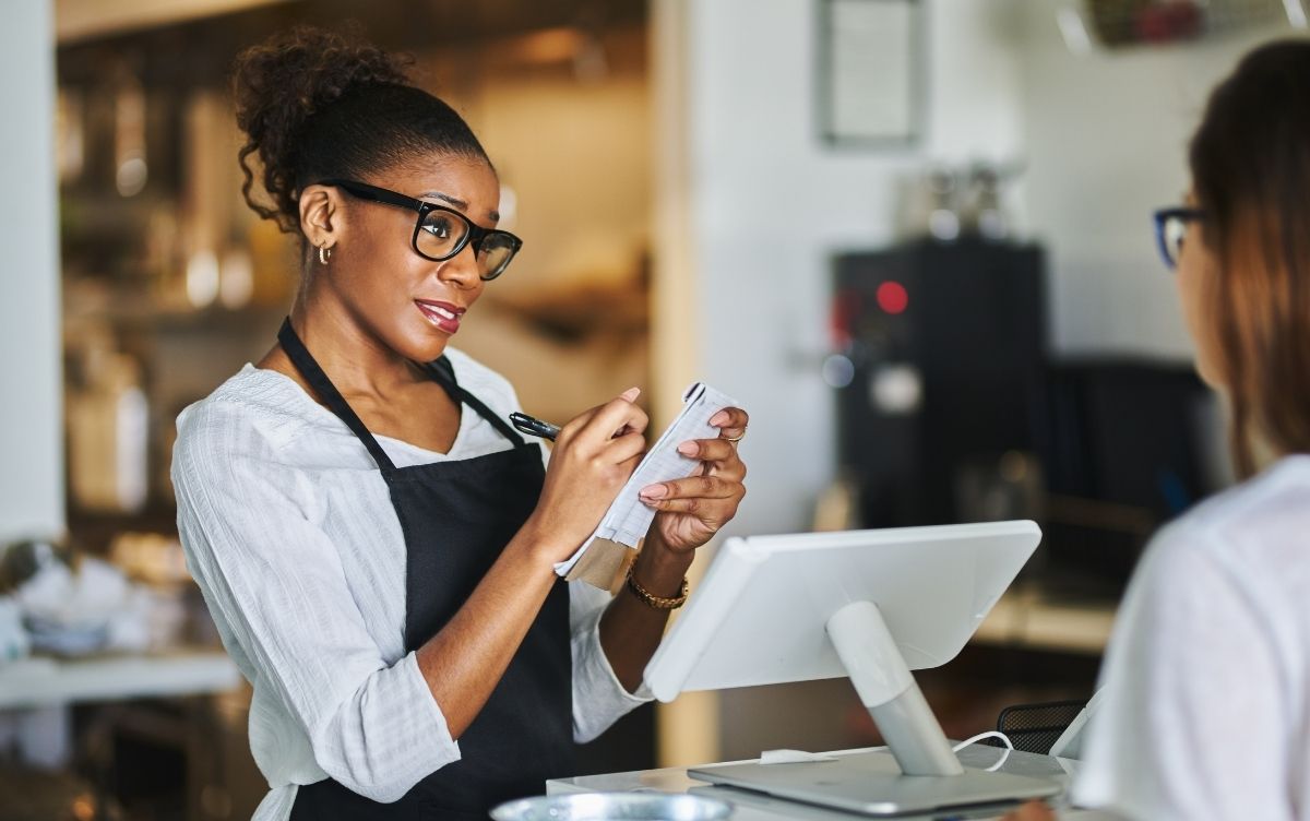 Waiteress taking an order from a customer in a cafe